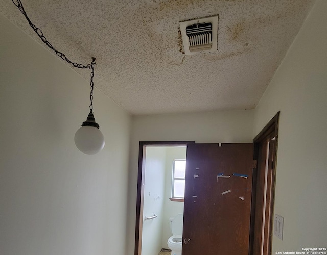 details featuring a textured ceiling and visible vents