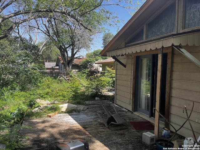view of property exterior with a wooden deck
