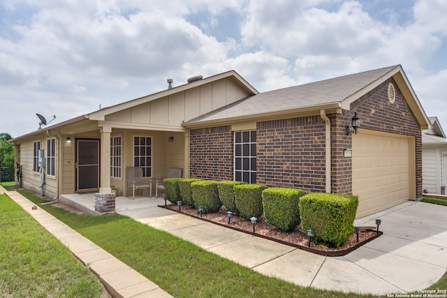 ranch-style house with an attached garage, brick siding, a front yard, and driveway