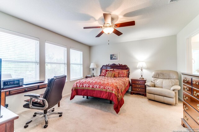 bedroom with carpet flooring, an office area, and ceiling fan
