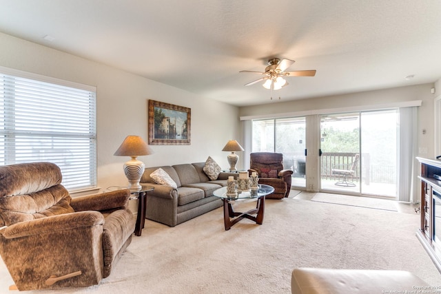 living room with light colored carpet and ceiling fan