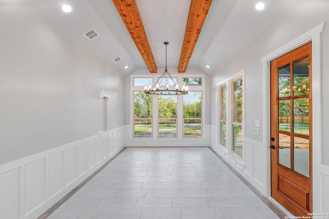 interior space featuring visible vents, a decorative wall, wainscoting, and vaulted ceiling with beams