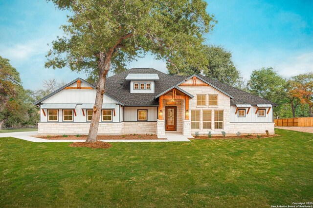 LOT29 Hondo Dr, La Vernia, TX 78121 - view of front of home featuring fence, a shingled roof, stone siding, and a front yard