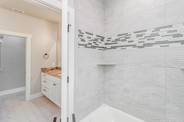 full bathroom with visible vents, baseboards, vanity, and shower / bathtub combination