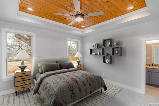 bedroom featuring wooden ceiling, baseboards, a raised ceiling, and a sink