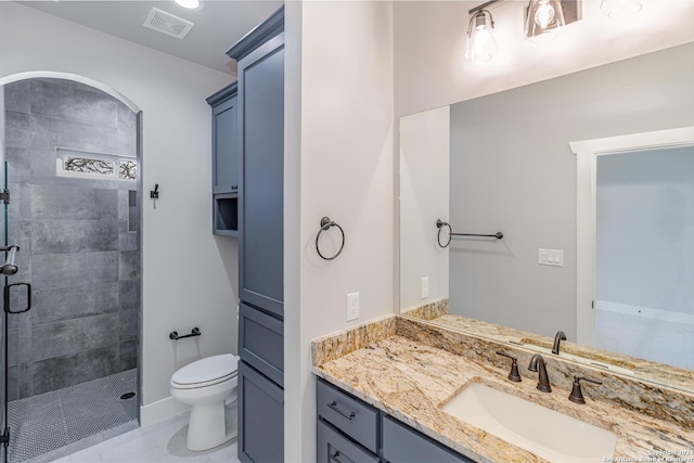 full bathroom featuring a stall shower, toilet, visible vents, tile patterned flooring, and vanity