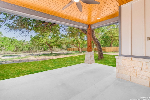 view of patio featuring a ceiling fan and fence