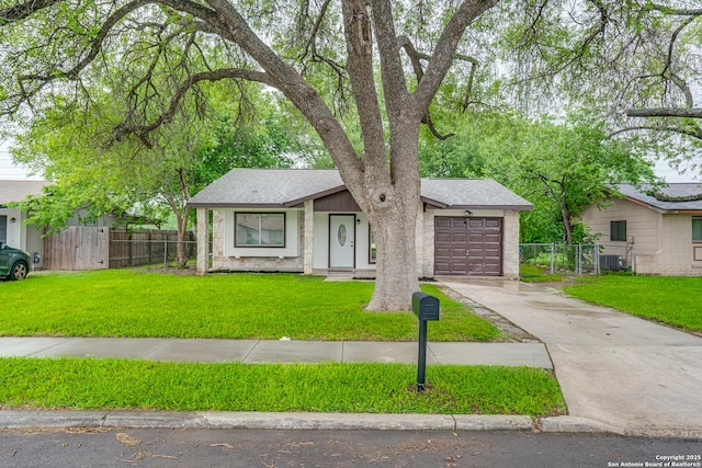 single story home with fence, a garage, a front lawn, and concrete driveway