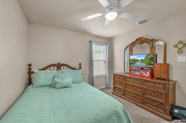 bedroom featuring baseboards, ceiling fan, light carpet, and visible vents