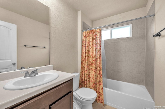 bathroom featuring toilet, shower / bath combo, vanity, and a textured wall