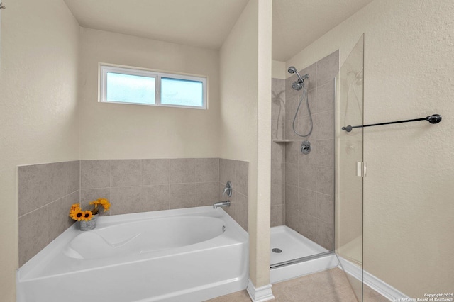 bathroom featuring a garden tub and a stall shower