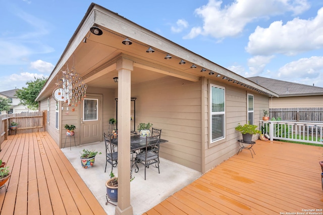 deck featuring a patio area, outdoor dining space, and fence