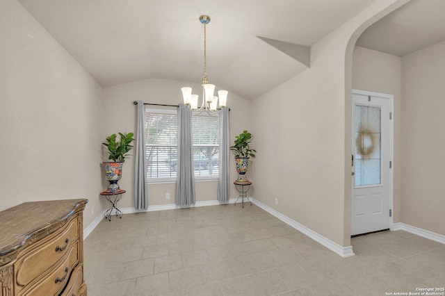 dining area featuring lofted ceiling, a notable chandelier, arched walkways, and baseboards