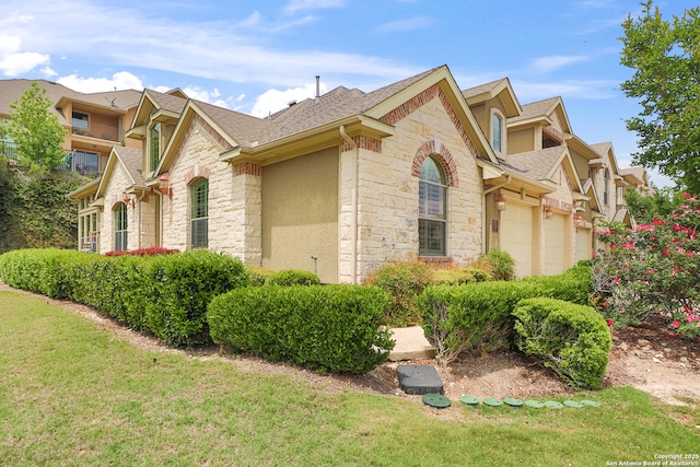 8250 Cruiseship Bay Unit, San Antonio, TX 78255 - view of property exterior with a yard, a shingled roof, and stone siding