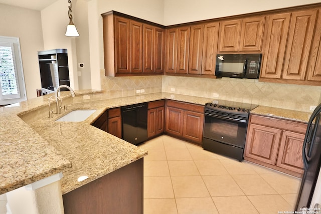 8250 Cruiseship Bay Unit, San Antonio, TX 78255 - kitchen featuring a sink, a peninsula, black appliances, decorative backsplash, and light stone countertops