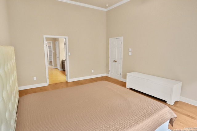 8250 Cruiseship Bay Unit, San Antonio, TX 78255 - bedroom featuring ornamental molding, light wood-style floors, a high ceiling, and baseboards
