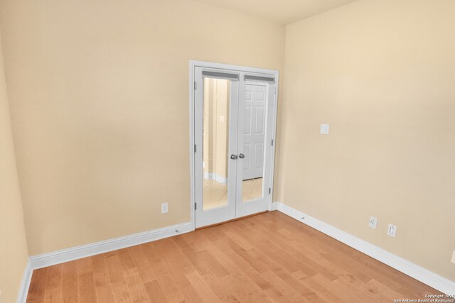 8250 Cruiseship Bay Unit, San Antonio, TX 78255 - unfurnished room with french doors, light wood-style floors, and baseboards
