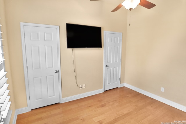 8250 Cruiseship Bay Unit, San Antonio, TX 78255 - unfurnished bedroom with baseboards, light wood-style floors, and a ceiling fan