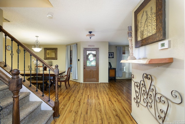 18554 Taylore Run, San Antonio, TX 78259 - entrance foyer featuring stairway, light wood-style floors, and a textured ceiling