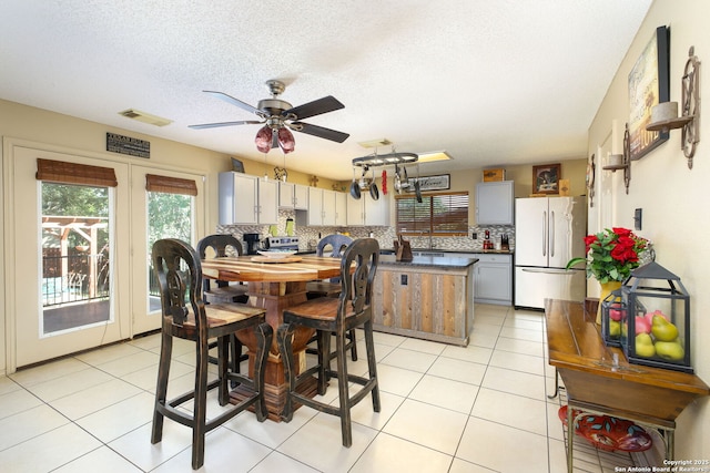 18554 Taylore Run, San Antonio, TX 78259 - dining room featuring french doors, ceiling fan, light tile patterned floors, and a textured ceiling