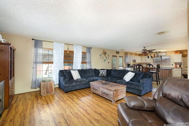 18554 Taylore Run, San Antonio, TX 78259 - living area with a textured ceiling, light wood finished floors, and a ceiling fan