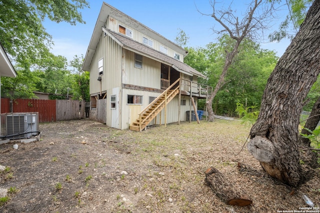 1030 Elsmere, San Antonio, TX 78201 - rear view of property with roof with shingles, stairs, cooling unit, and fence