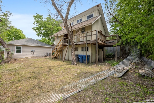 1030 Elsmere, San Antonio, TX 78201 - rear view of property featuring a lawn, stairs, a wooden deck, and board and batten siding