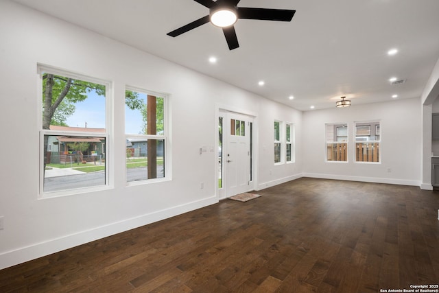 1030 Elsmere, San Antonio, TX 78201 - unfurnished living room with visible vents, baseboards, dark wood-type flooring, and recessed lighting