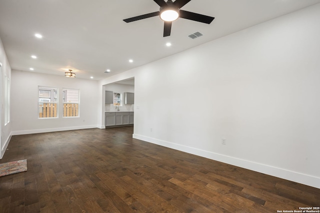 1030 Elsmere, San Antonio, TX 78201 - unfurnished living room featuring visible vents, baseboards, ceiling fan, dark wood-style floors, and recessed lighting