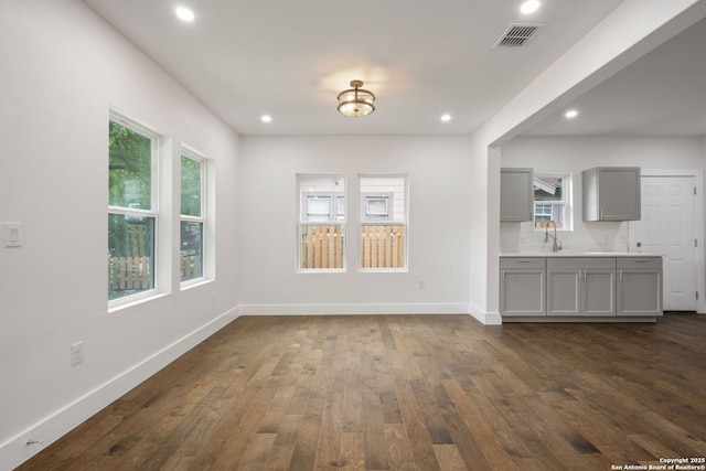 1030 Elsmere, San Antonio, TX 78201 - unfurnished dining area with baseboards, dark wood finished floors, recessed lighting, and visible vents