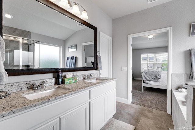 bathroom with double vanity, visible vents, a shower stall, and a sink