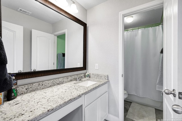 bathroom featuring toilet, visible vents, vanity, and a shower with curtain