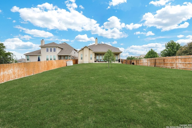 view of yard with a fenced backyard