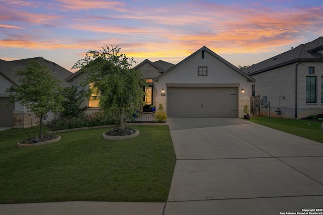 view of front facade featuring a yard, driveway, stucco siding, and a garage