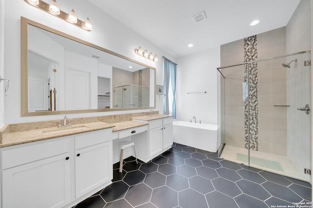 full bath with a freestanding bath, visible vents, a stall shower, and a sink