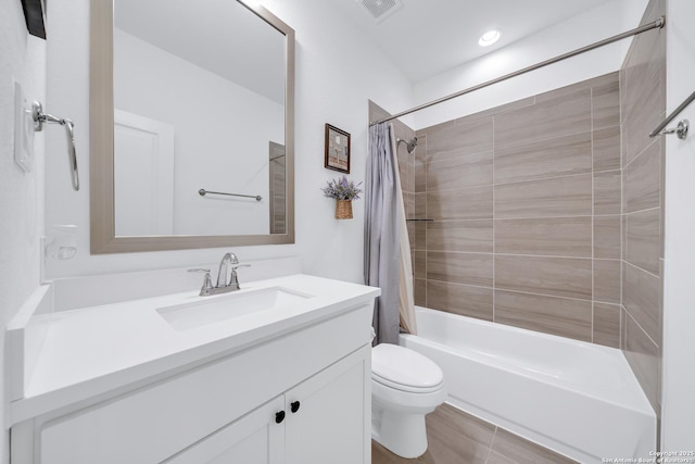 bathroom with toilet, shower / tub combo, visible vents, and vanity