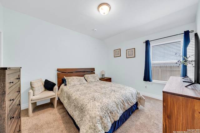 bedroom with baseboards, light colored carpet, and vaulted ceiling