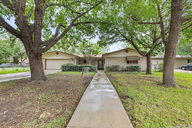 616 Ridgecrest, New Braunfels, TX 78130 - single story home with an attached garage, fence, concrete driveway, a front lawn, and brick siding