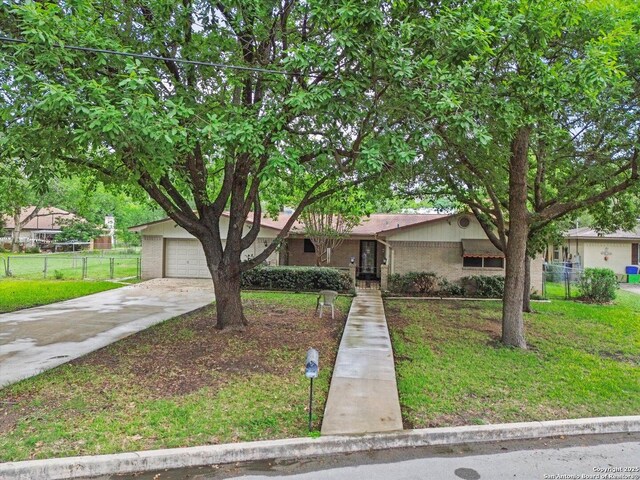 616 Ridgecrest, New Braunfels, TX 78130 - view of front facade featuring concrete driveway, a garage, fence, and a front yard