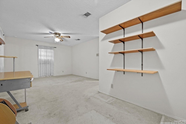 616 Ridgecrest, New Braunfels, TX 78130 - spare room with light colored carpet, a textured ceiling, visible vents, and a ceiling fan
