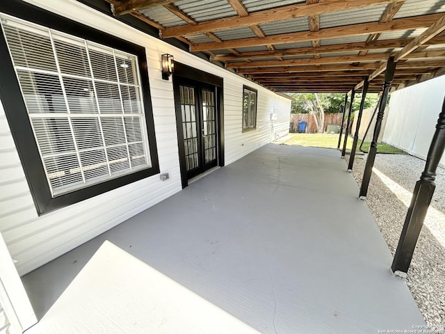 view of patio featuring french doors and fence