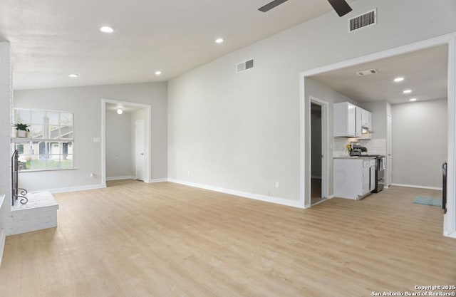 unfurnished living room with light wood-type flooring, ceiling fan, visible vents, and vaulted ceiling