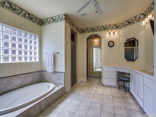 full bathroom featuring a garden tub, a ceiling fan, visible vents, a shower stall, and vanity
