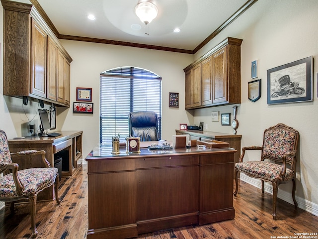 office area featuring crown molding, baseboards, ceiling fan, and dark wood finished floors