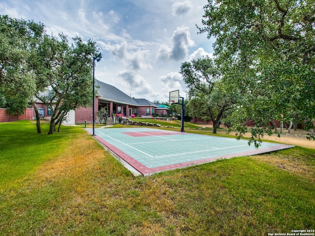 view of sport court featuring a lawn and community basketball court