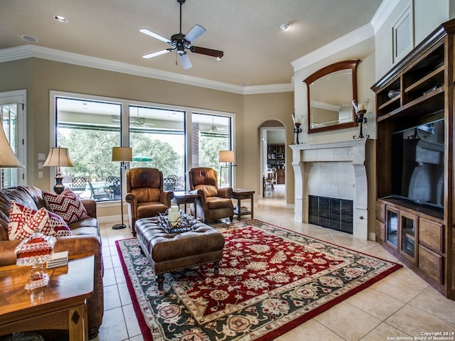 living area with light tile patterned floors, ceiling fan, and plenty of natural light