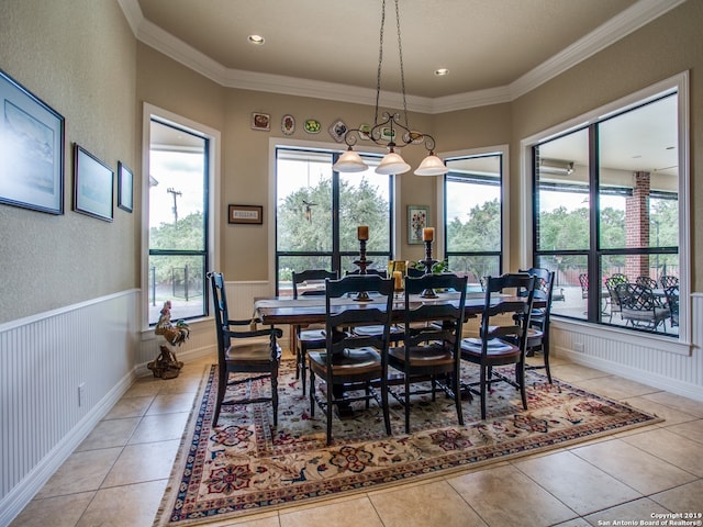 dining area featuring a wainscoted wall, ornamental molding, light tile patterned flooring, recessed lighting, and a textured wall