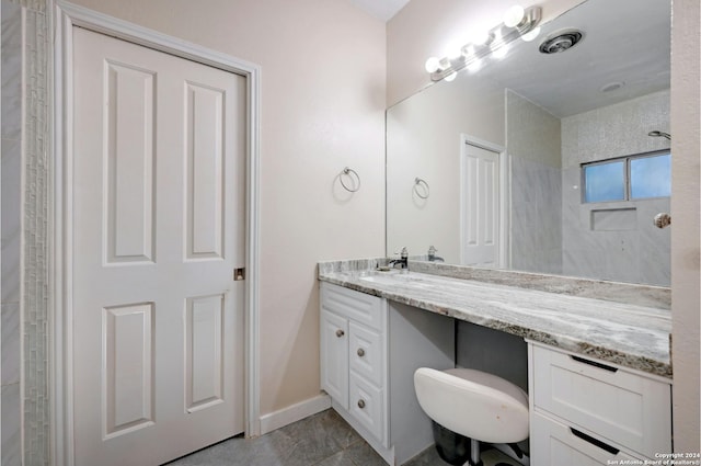 bathroom with baseboards and vanity