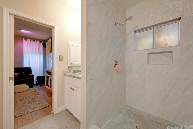 bathroom featuring vanity and tiled shower