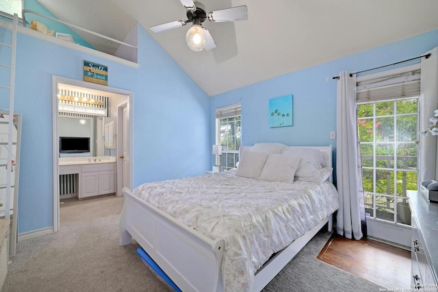 bedroom with connected bathroom, a ceiling fan, and lofted ceiling
